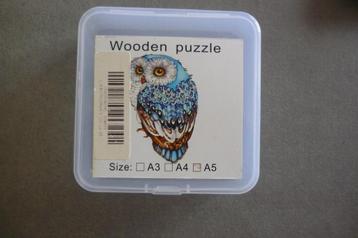 Houten puzzel (A5) '' UIL '' + poster 130 stukjes.