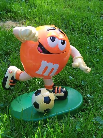 Snoepdispenser. Oranje M & M.