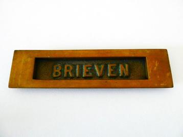 Oude kleine brievenbusklep met daarop brieven