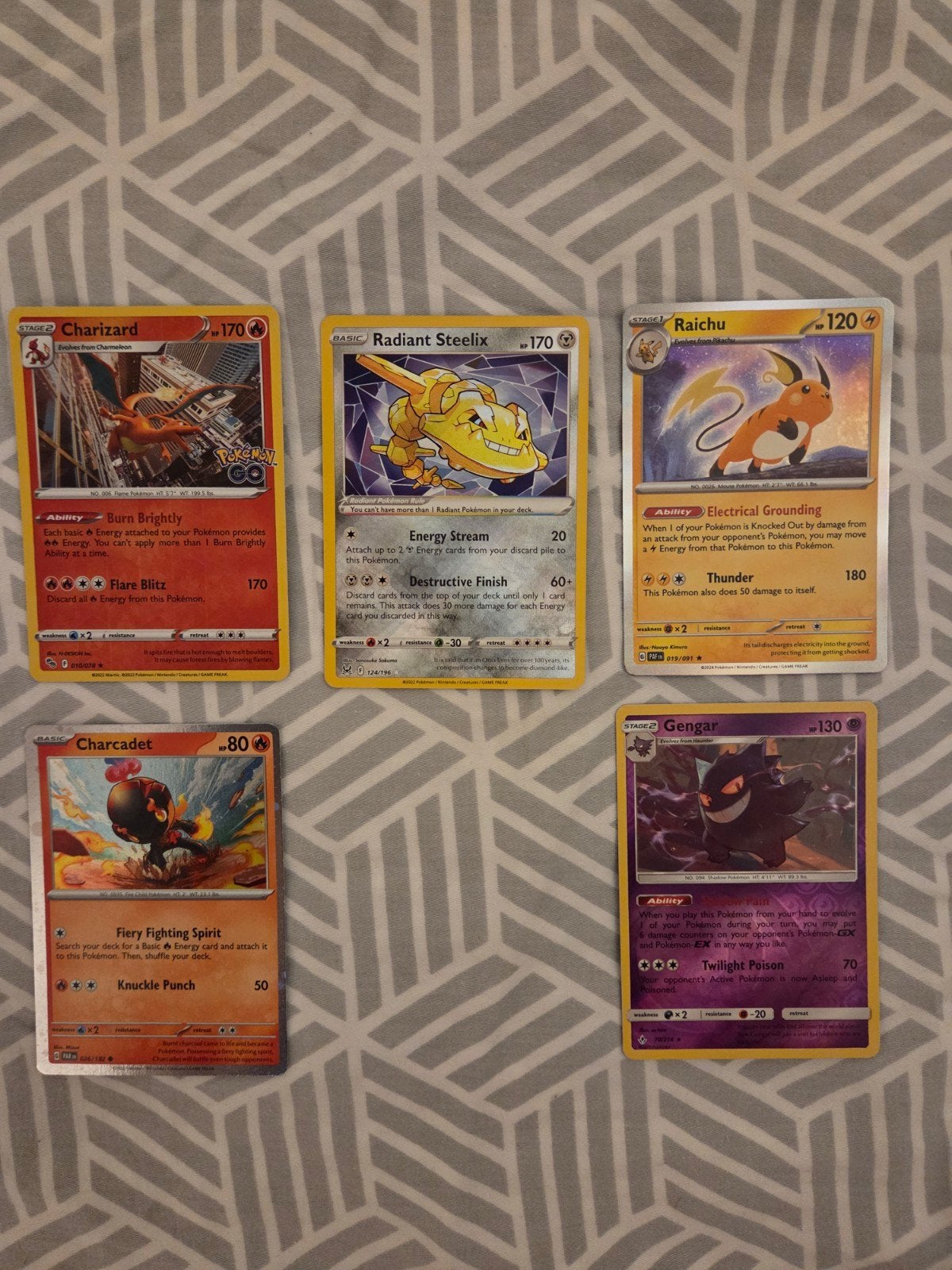 Charizard, Radiant Steelix, Raichu, Charcadet MINT, Ophalen of Verzenden, Nieuw, Meerdere kaarten, Foil