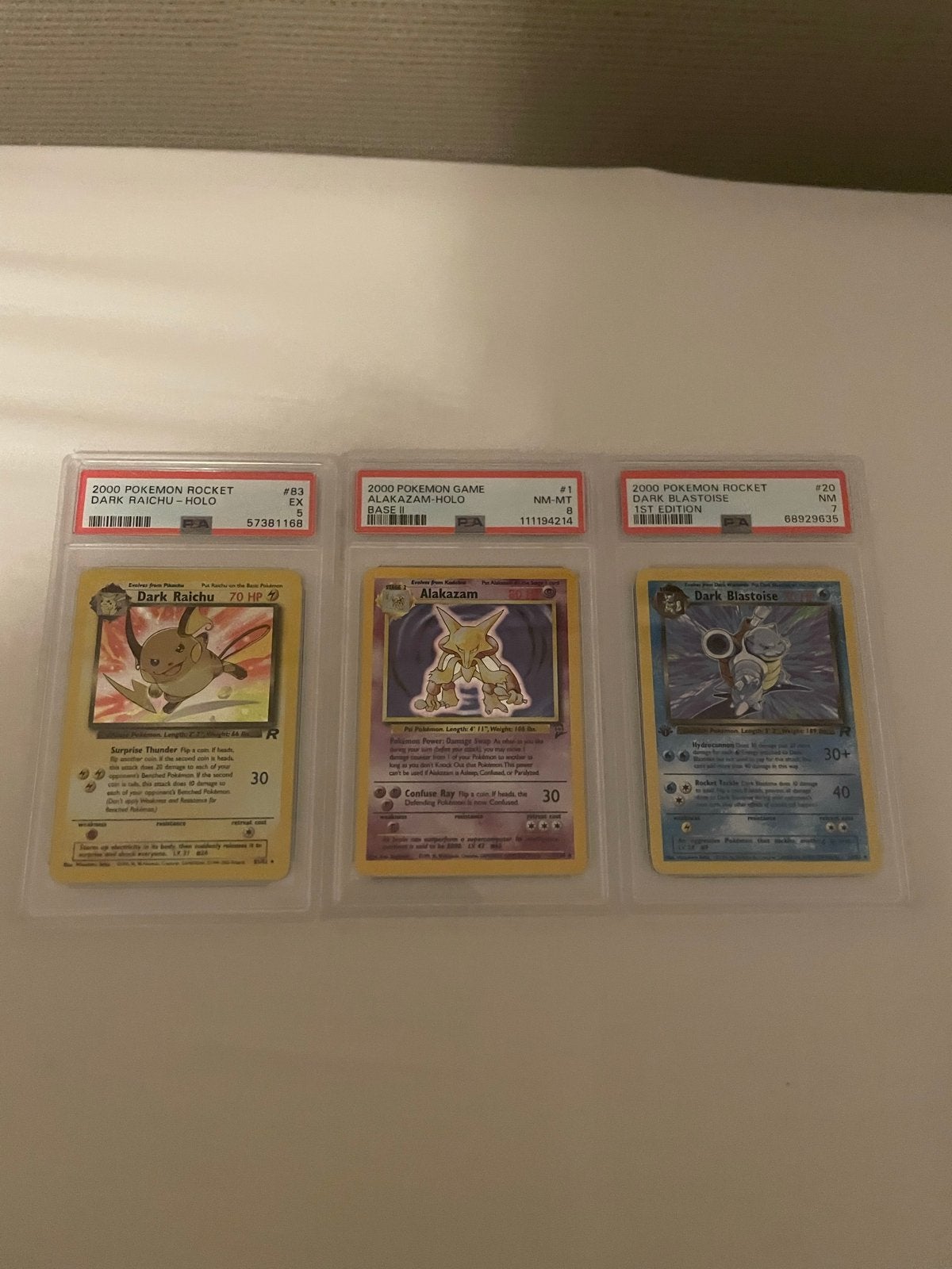 PSA Graded Pokémon Kaarten: Dark Raichu, Alakazam, Dark Blas, Hobby en Vrije tijd, Ophalen of Verzenden, Zo goed als nieuw, Losse kaart