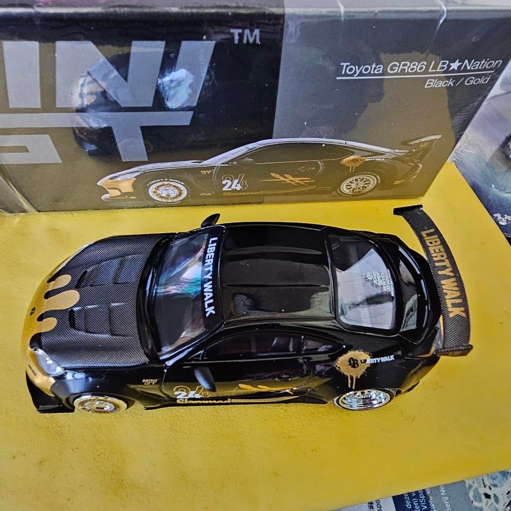Mini GT Toyota GR86 LBNation Zwart/Goud Modelauto, Niet gespecificeerd, algemeen modelautomerk, Nieuw, Ophalen of Verzenden, Niet gespecificeerd