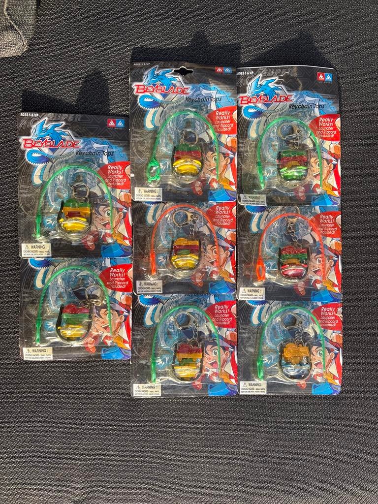8 Beyblade sleutelhangers - Nieuw in verpakking, Ophalen of Verzenden, Nieuw, Jongen of Meisje