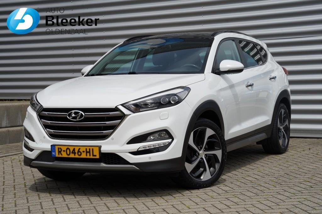 Hyundai Tucson 1.6 T-GDI 177PK Premium 4WD Ecc Cruise Navi P, Auto's, Gebruikt, 1591 cc, 4 cilinders, Wit