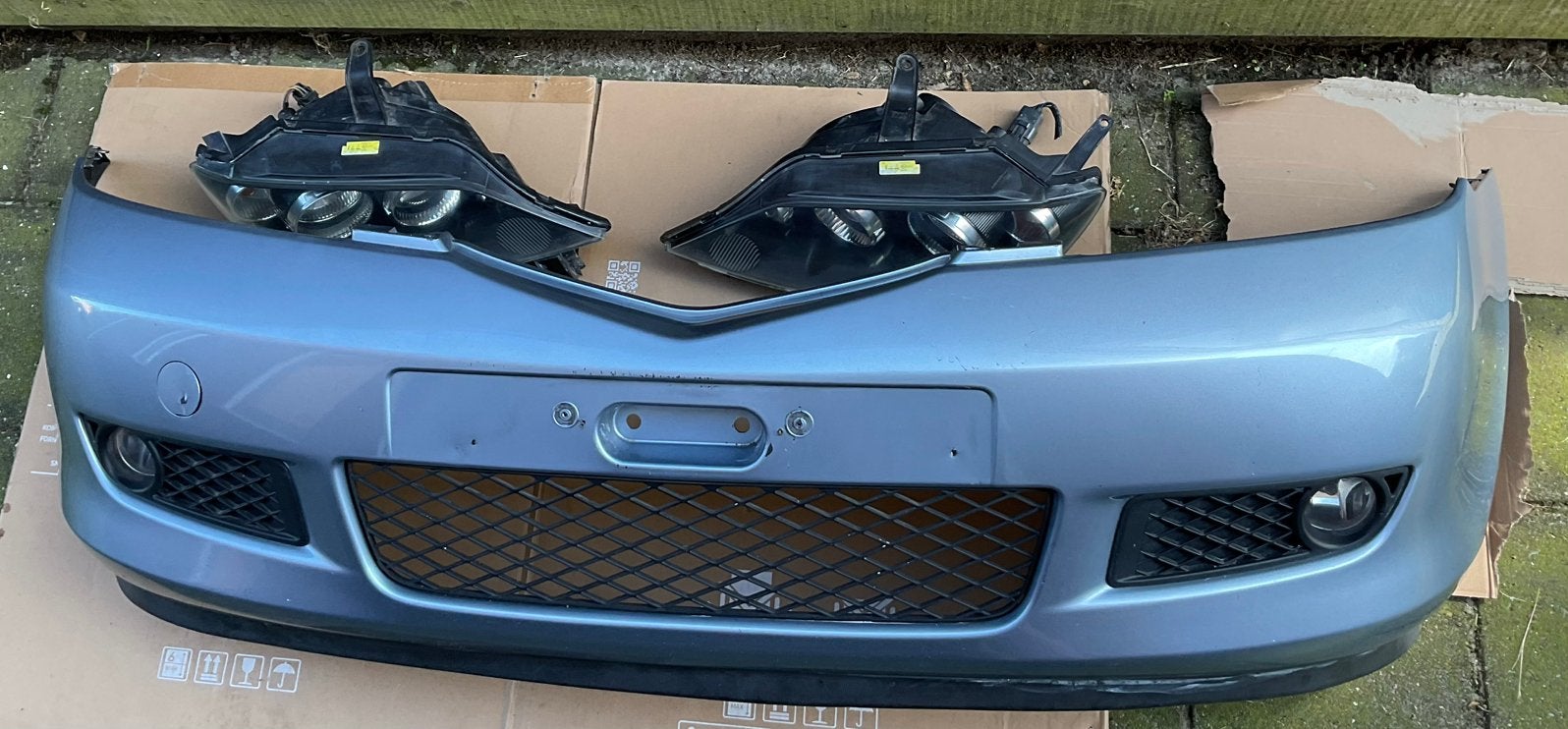Mazda 2 facelift voorbumper met koplampen, Gebruikt, Voor, Ophalen of Verzenden, Mazda