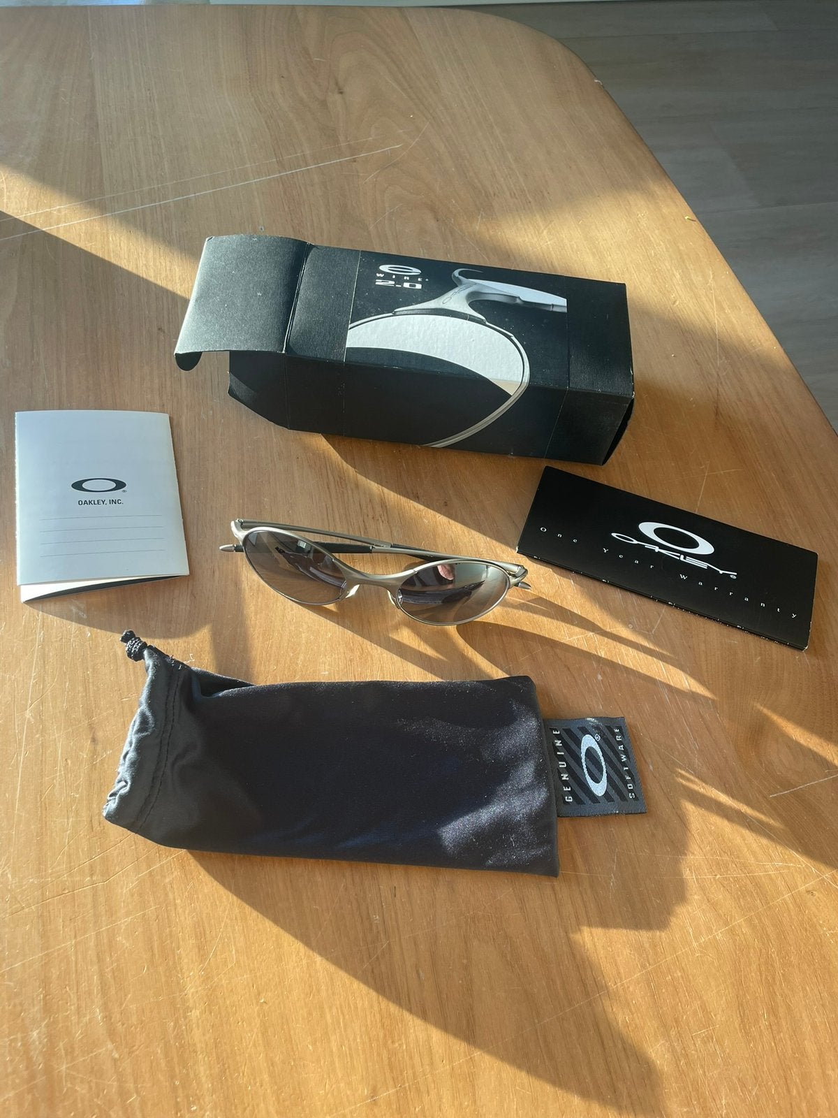 Oakley E-Wire Black Iridium, Ophalen of Verzenden, Zo goed als nieuw, Zwart