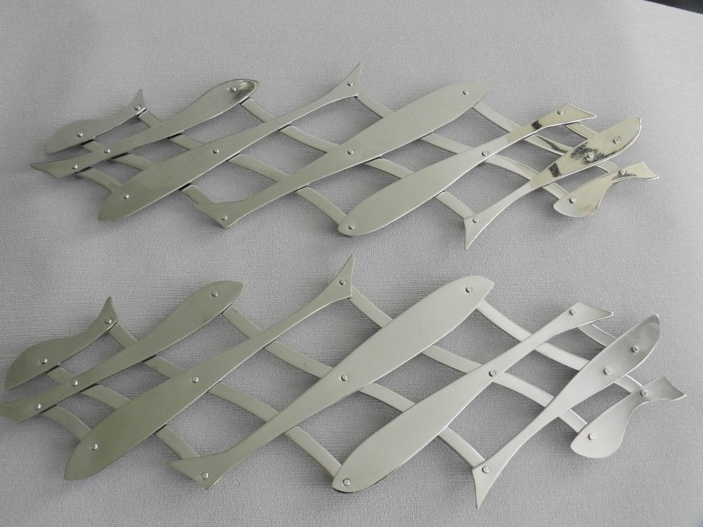 Set van 2 Alessi "Pescher" Onderzetters., Antiek en Kunst, Kunst | Designobjecten, Ophalen of Verzenden, Overige typen, Metaal