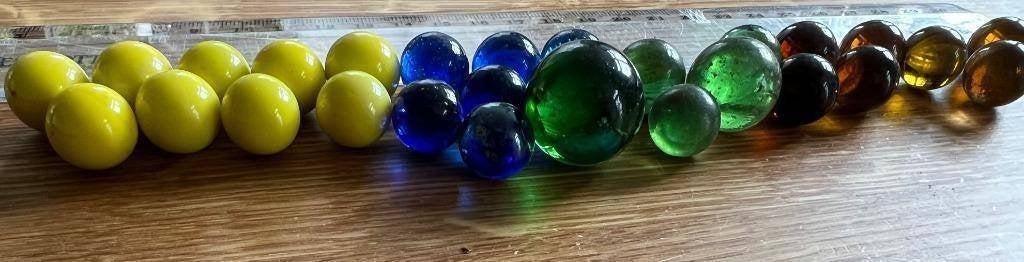 27 glazen knikkers geel blauw groen bruin, Ophalen of Verzenden