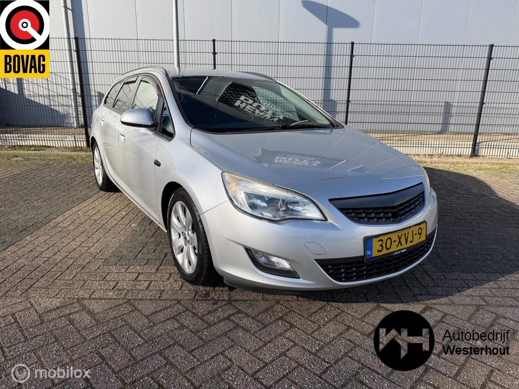 Opel Astra Sports Tourer 1.4 Cosmo Airco Navi Parkeersensore, Auto's, Voorwielaandrijving, Euro 5, 101 pk, Gebruikt