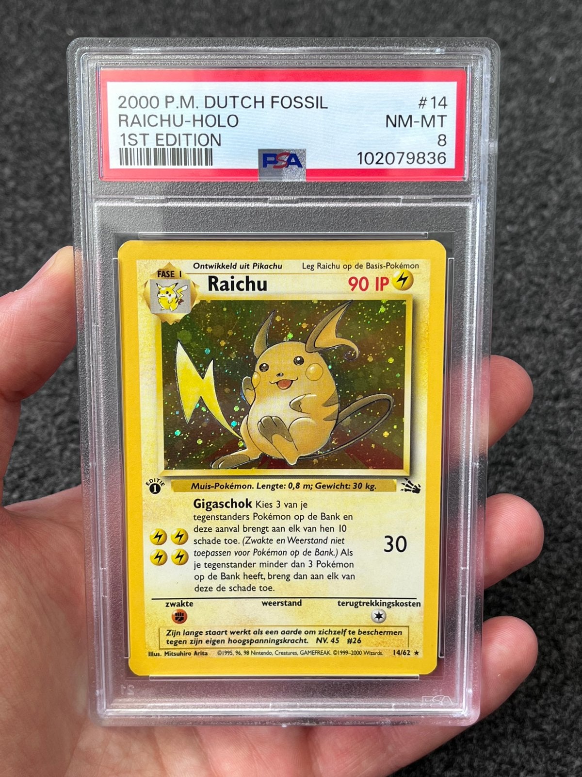 Pokémon PSA 8 Dutch 1st Ed. Raichu Holo #14 Fossil (POP 17), Ophalen of Verzenden, Zo goed als nieuw, Losse kaart, Foil