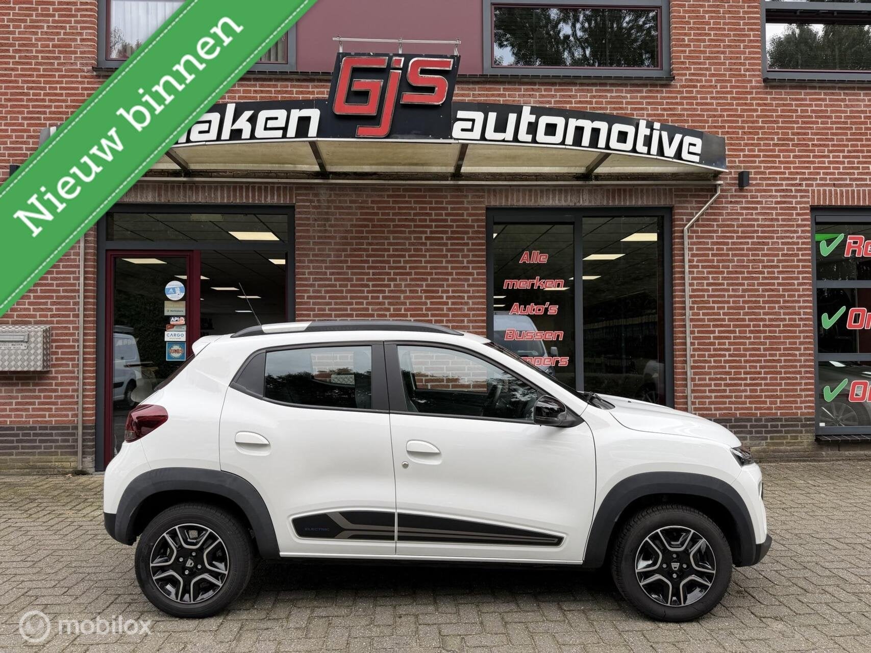 Dacia Spring Comfort Plus (Orange Pack) 27 kWh, Auto's, Dealer onderhouden, Gebruikt, 230 km, Leder en Stof