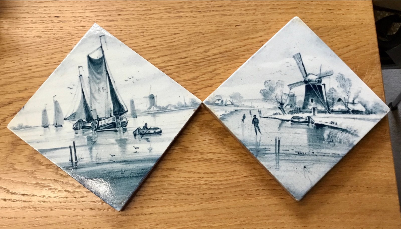 2 blauwe tegels van Ostera met Hollandse taferelen, Ophalen of Verzenden