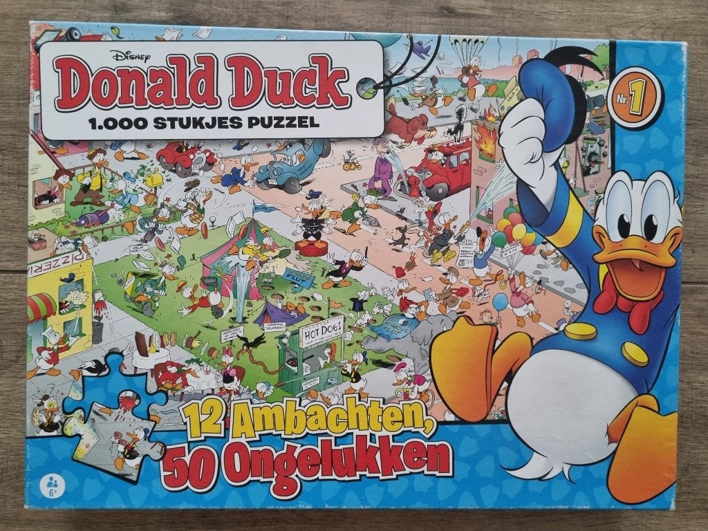 Puzzel Donald Duck, 1000 stukjes,12 ambachten, 50 ongelukken, Ophalen of Verzenden, 500 t/m 1500 stukjes, Zo goed als nieuw, Legpuzzel