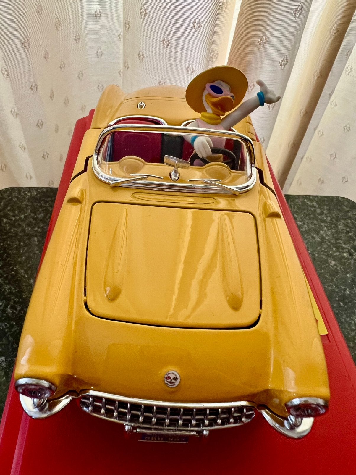 vrolijke Daisy Duck in Chevrolet Corvette (1957) Bburago, Ophalen, Overige figuren, Zo goed als nieuw, Beeldje of Figuurtje