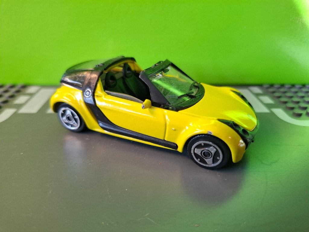 Bburago - Smart Roadster [geel] 1/43, Ophalen of Verzenden, Gebruikt, Auto, Overige merken