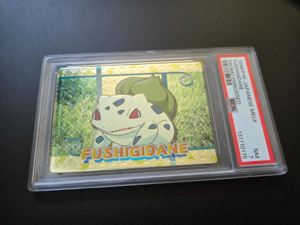 Bulbasaur 1999 Pokemon Japanese Meiji Embossed Promo PSA 7, Ophalen of Verzenden, Nieuw, Losse kaart, Foil