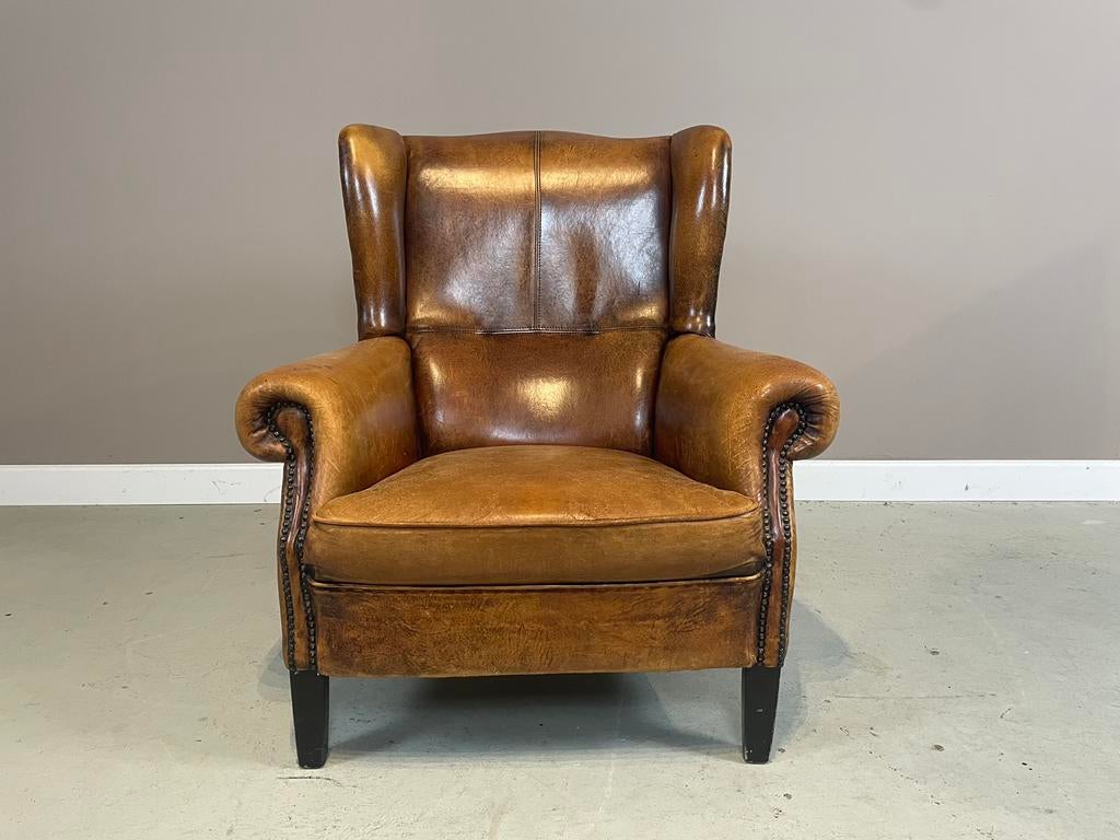Schapenleren oorfauteuil DNG (laag model) in topstaat, Huis en Inrichting, Fauteuils, Ophalen, Zo goed als nieuw, Leer