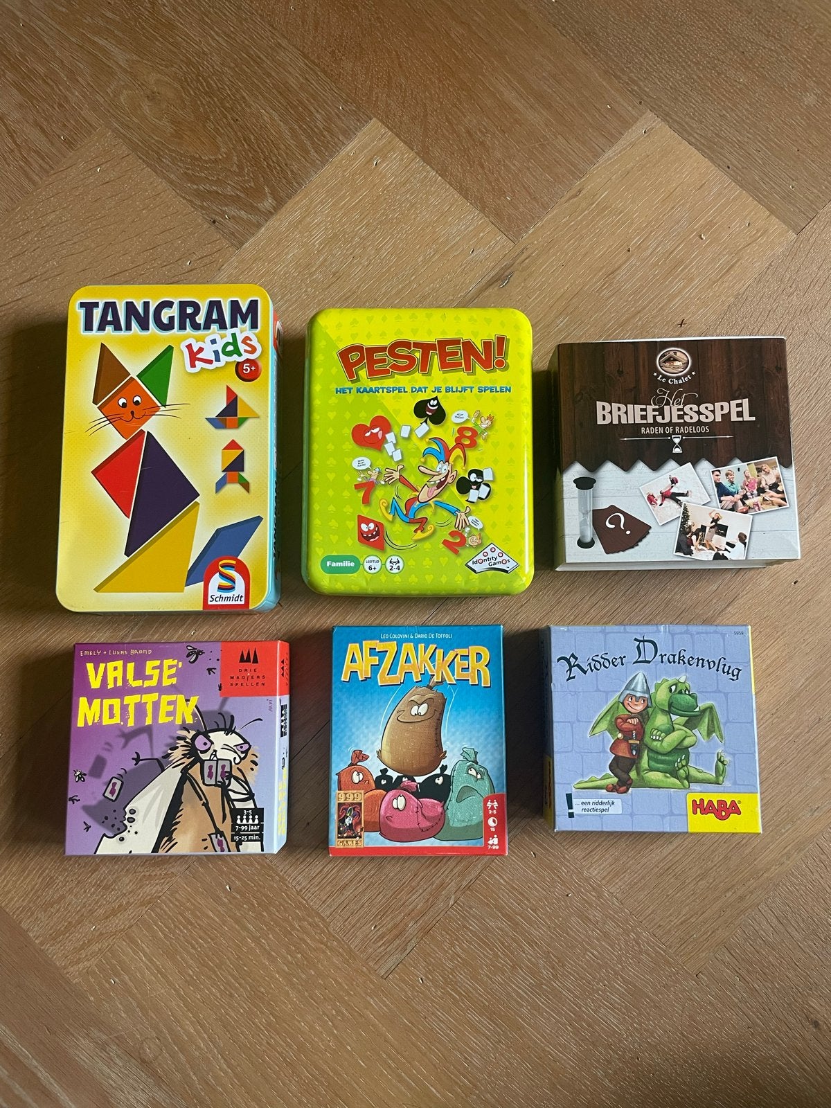 Bordspellen en kaartspellen: Tangram, Pesten, Briefjesspel e, Drie of vier spelers, Ophalen, Zo goed als nieuw, Reisspel