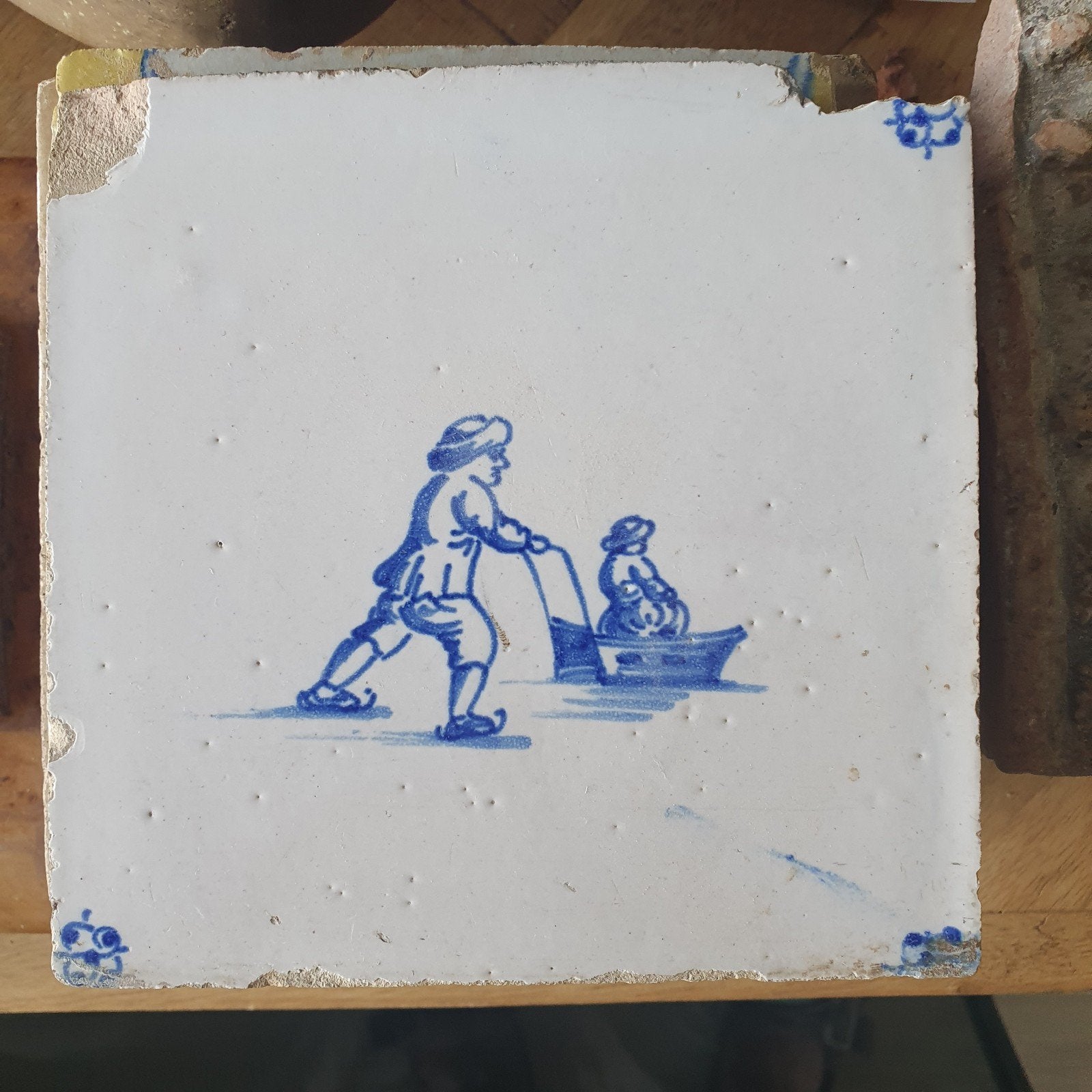 Antieke Delfts blauwe Tegel: Schaatser met kind in slee., Antiek en Kunst, Ophalen of Verzenden