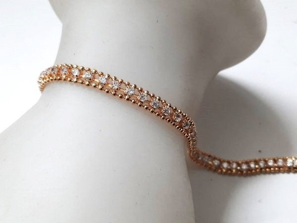 Schitterende goudkleurige Tennisarmband met strass (7902), Ophalen, Overige materialen, Nieuw, Goud