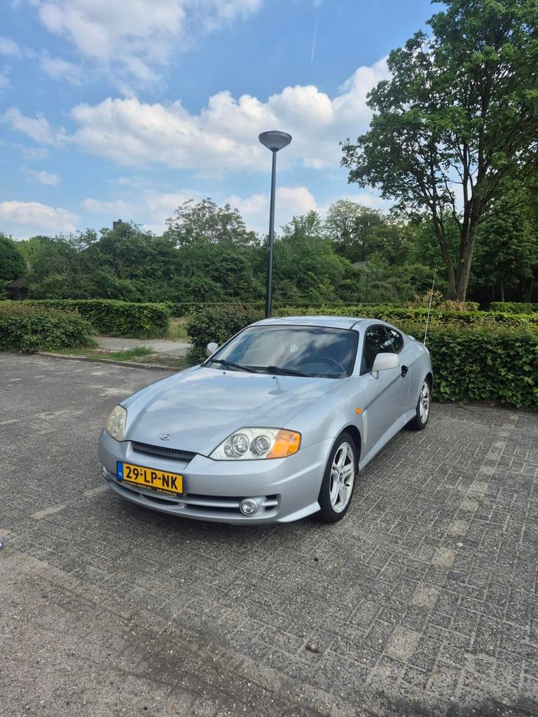 Hyundai Coupé 2.0 2003 Grijs, Auto's, Hyundai, Stof, Zwart, 4 stoelen, Origineel Nederlands