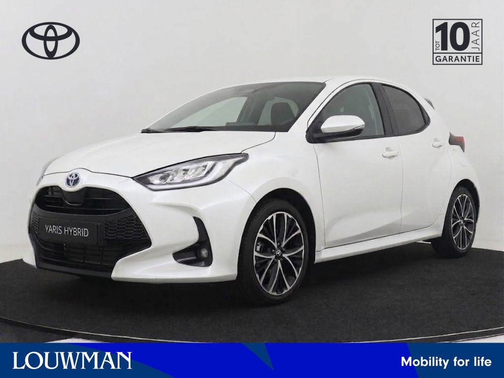 Toyota Yaris 1.5 Hybrid 115 Dynamic I NIEUW & DIRECT LEVERBA, Auto's, Wit, Nieuw, Hybride Elektrisch/Benzine, 3 cilinders