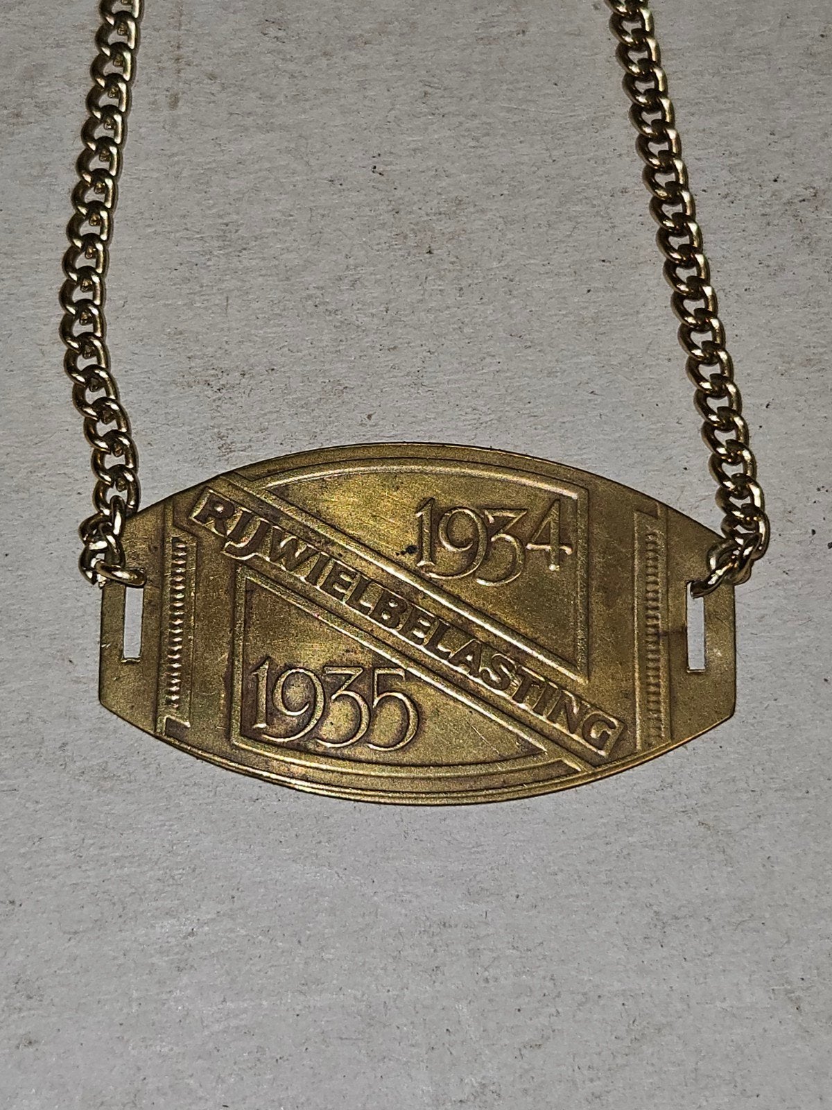 Rijwielbelastingplaatje Nederland 1934-1935 Messing, Ophalen of Verzenden