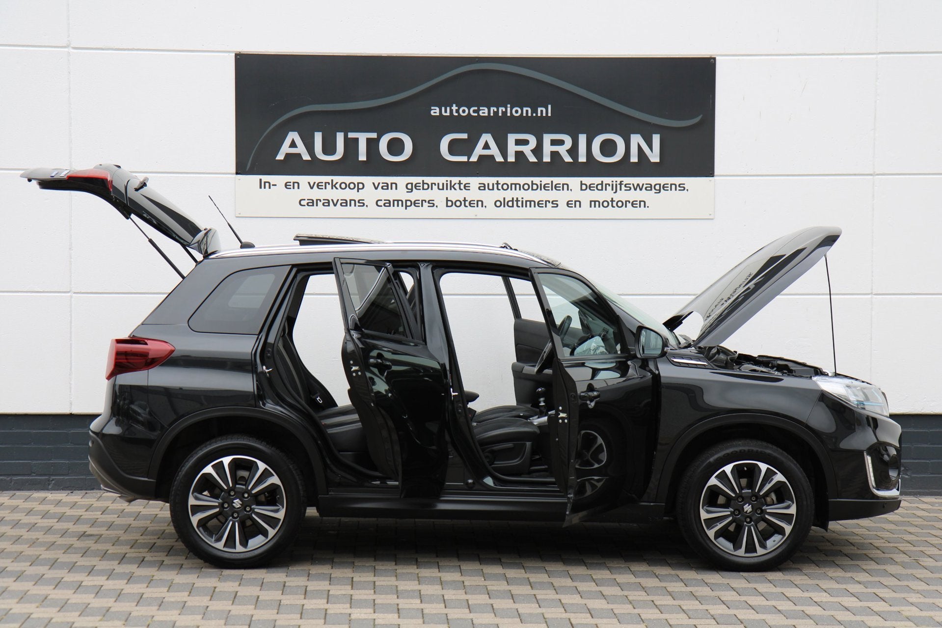 Suzuki Vitara 1.4 Boosterjet Style Smart Hybrid Pano Carplay, Auto's, Dealer onderhouden, Gebruikt, Zwart, 4 cilinders