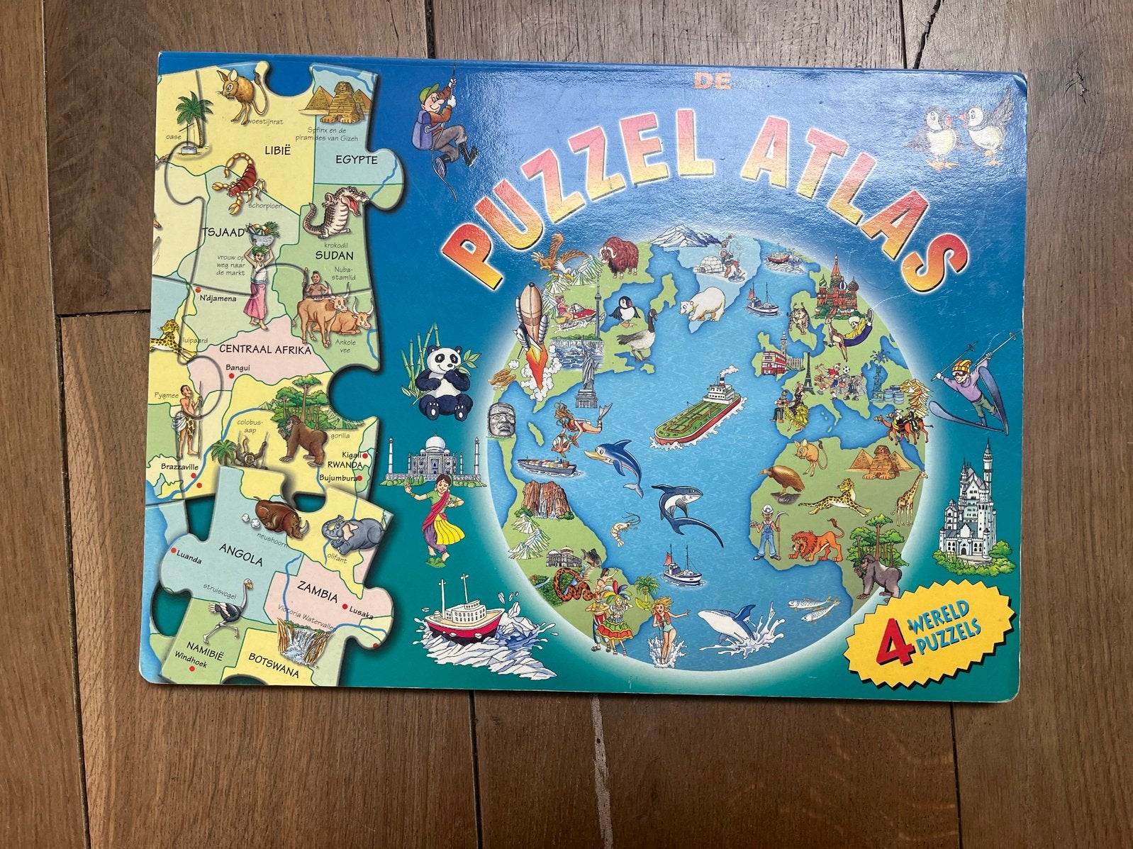 De Grote Wereld Puzzle Atlas - 4 Wereld Puzzels, Overige atlassen, 2000 tot heden, Ophalen of Verzenden, Zo goed als nieuw