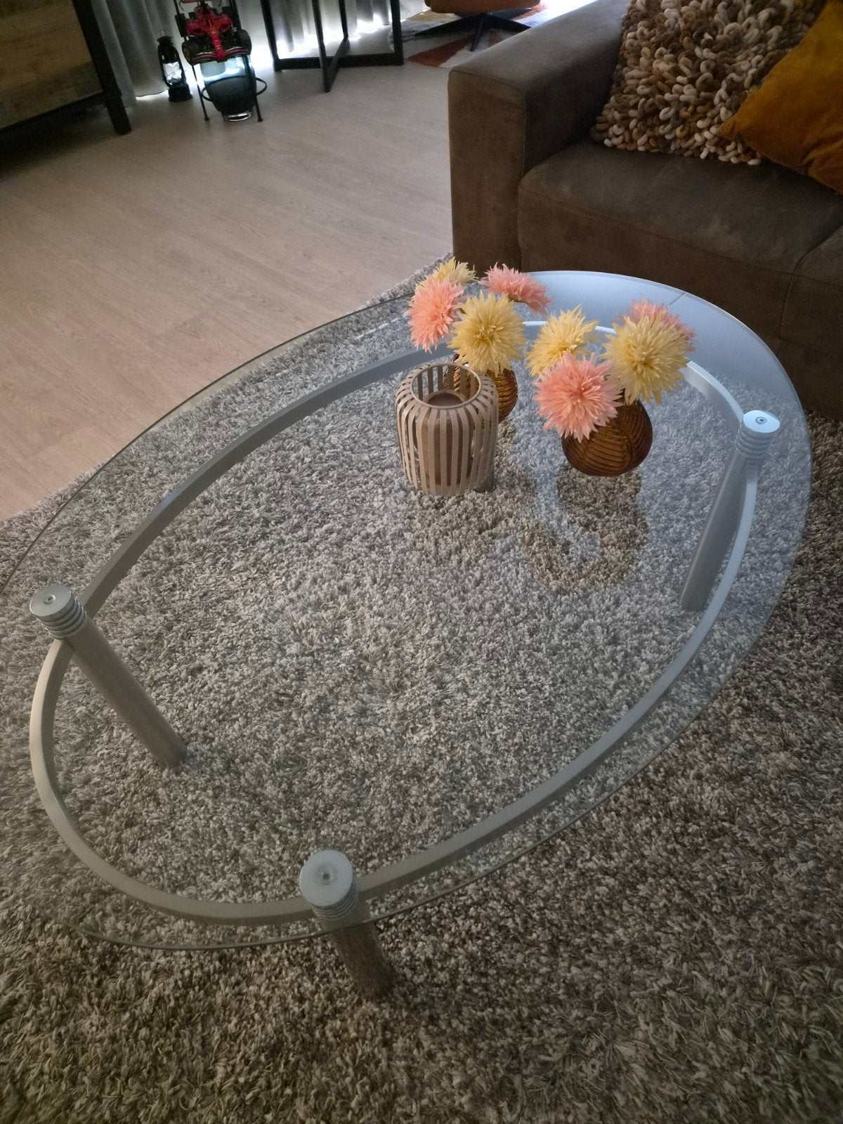 Ovale salontafel met glazen blad en RVS onderstel, Ophalen, Gebruikt, 100 tot 150 cm, 50 tot 100 cm