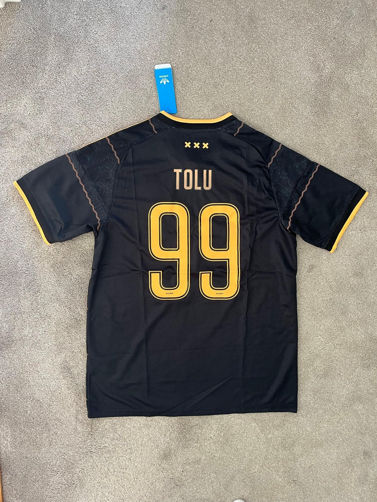Ajax uitshirt 2026/27 Tolu 99 - Maat L, Sport en Fitness, Maat L, Ophalen of Verzenden, Nieuw, Shirt