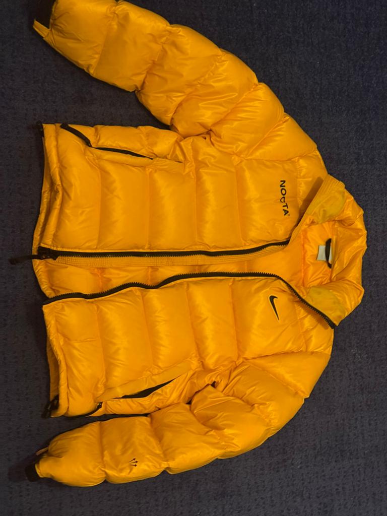 Nike x NOCTA Sunset Puffer Jacket Yellow, Kleding | Heren, Ophalen of Verzenden, Nieuw, Maat 48/50 (M), Geel