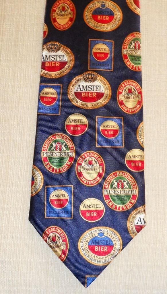 Amstel Bier stropdas met allemaal retro logo's, Kleding | Heren, Ophalen of Verzenden, Nieuw, Overige kleuren