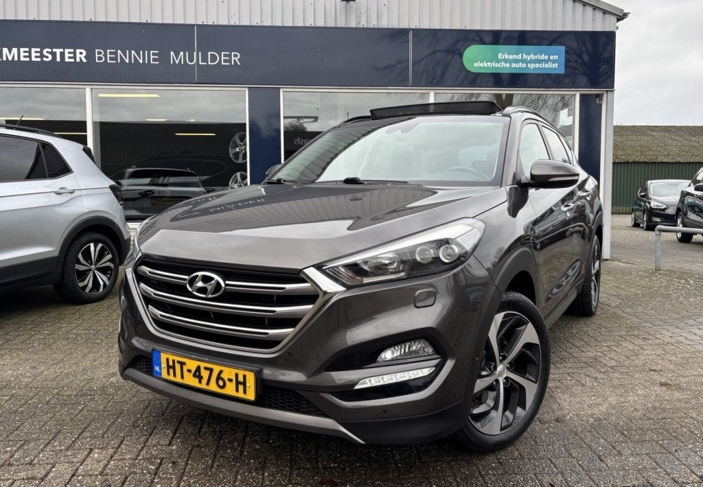 Hyundai Tucson 1.6 T-GDi Premium 4WD / AUT / SCHUIFDAK / LED, Auto's, Gebruikt, 4 cilinders, Bruin, Lichtsensor