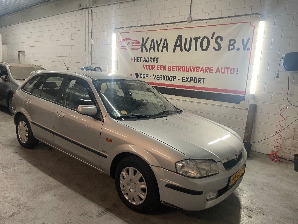 Mazda 323 1.5 F LX AIRCO AUT 2000 Grijs, Auto's, Mazda, 1498 cc, 4 cilinders, 400 kg, 1070 kg