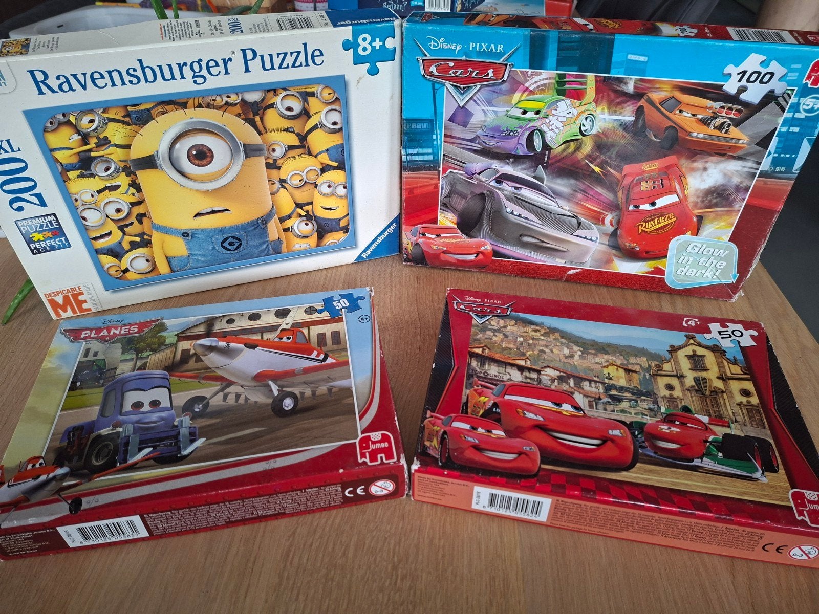 4 Disney/Minions Puzzels - Ravensburger, Cars, Planes, Ophalen of Verzenden, Meer dan 50 stukjes, Gebruikt, 4 tot 6 jaar