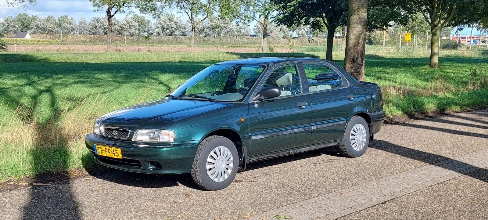 Suzuki Baleno 1.6 Sedan AUT 1998 Groen, Auto's, 4 cilinders, 965 kg, Origineel Nederlands, Grijs
