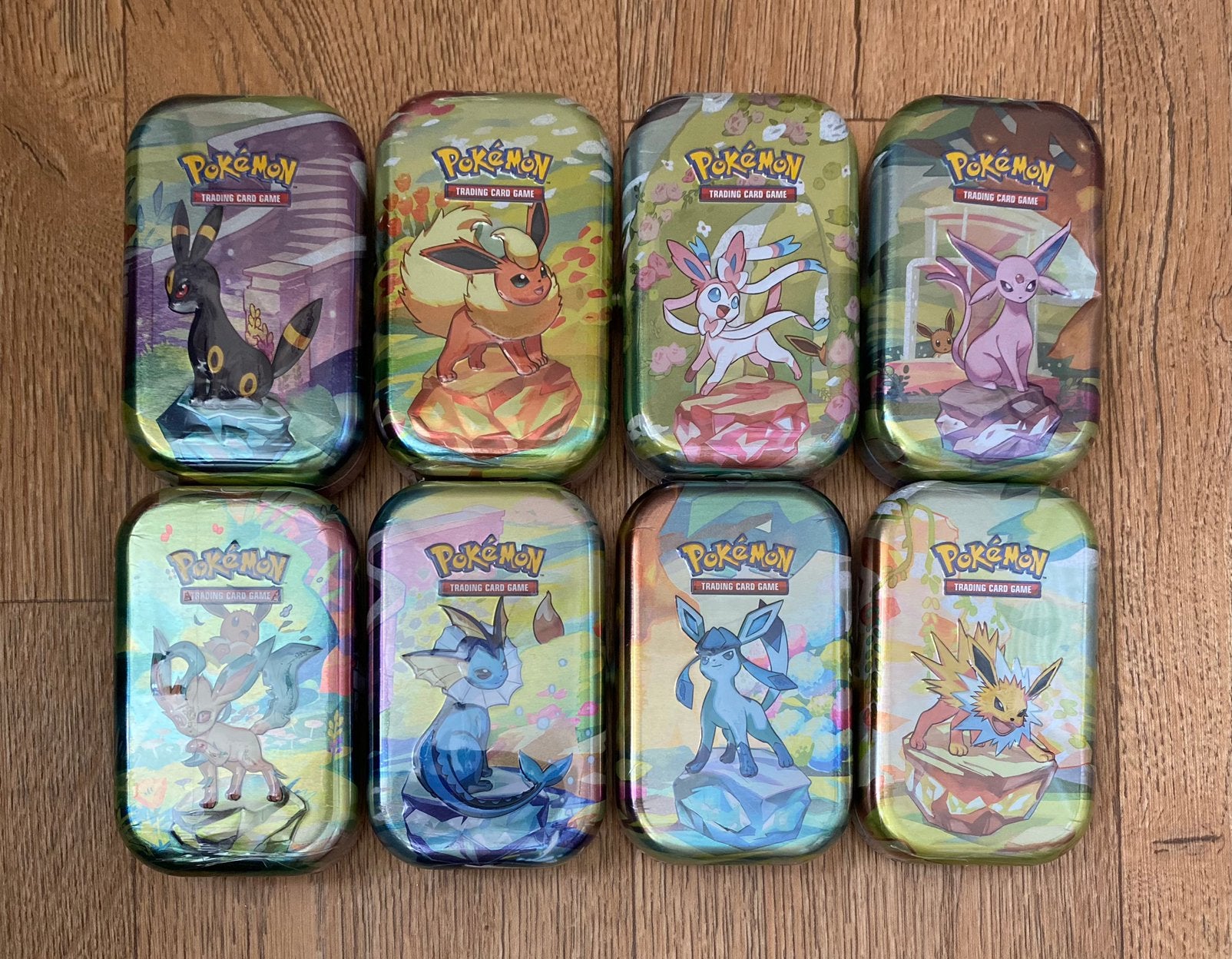 Pokémon TCG - Prismatic Evolutions Mini Tin ArtSet (8x tin), Ophalen of Verzenden, Nieuw, Foil