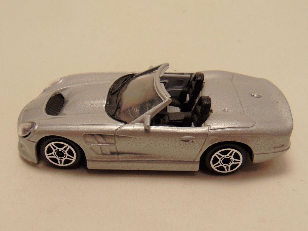 Shelby Series 1 1999 1:43 Bburago zilverkleurig, Ophalen of Verzenden, Gebruikt, Auto, Overige merken