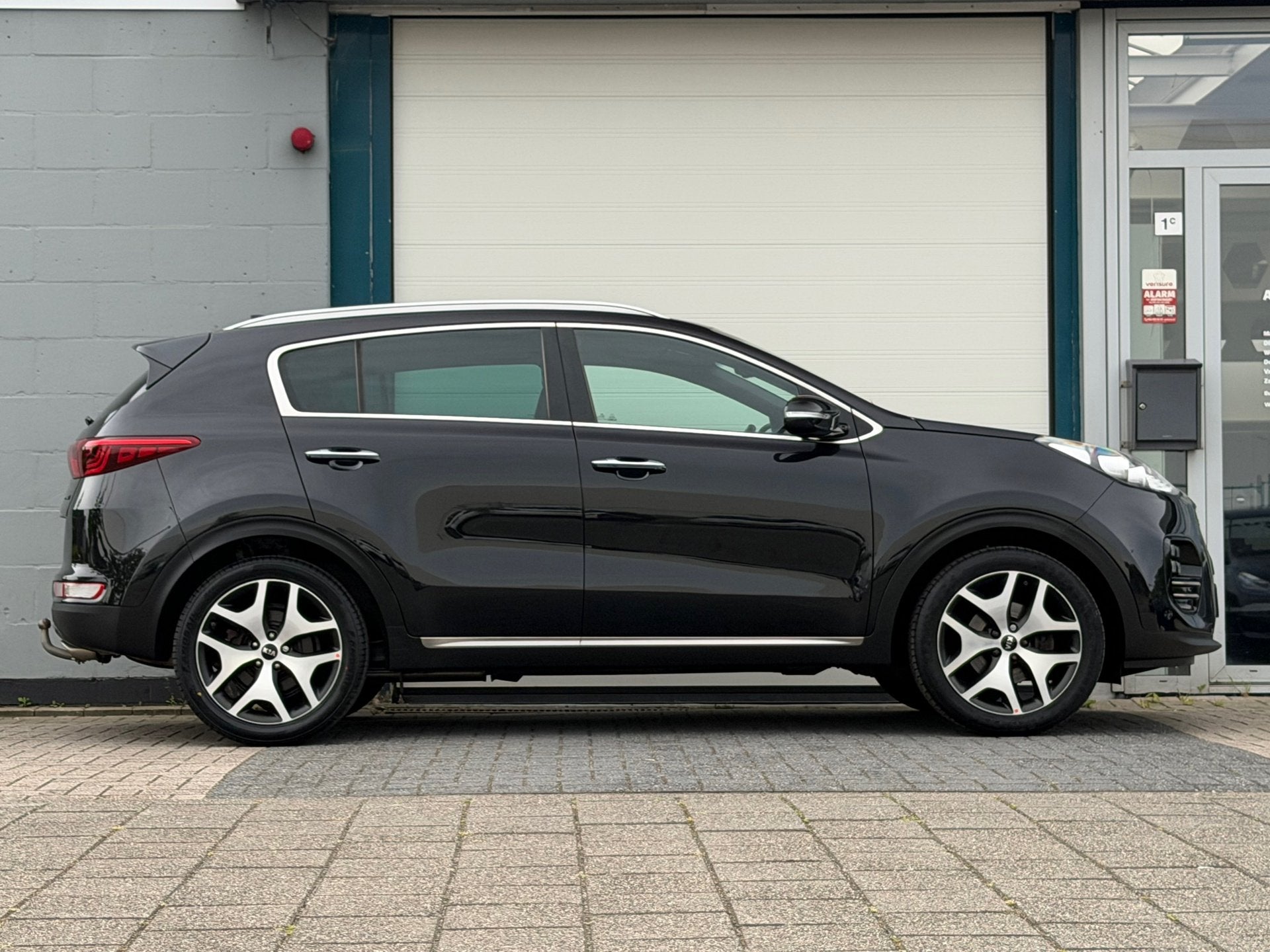 Kia Sportage 1.6 T-GDI 4WD GT-Line First Edition Automaat, Auto's, Gebruikt, 4 cilinders, Zwart, Bedrijf