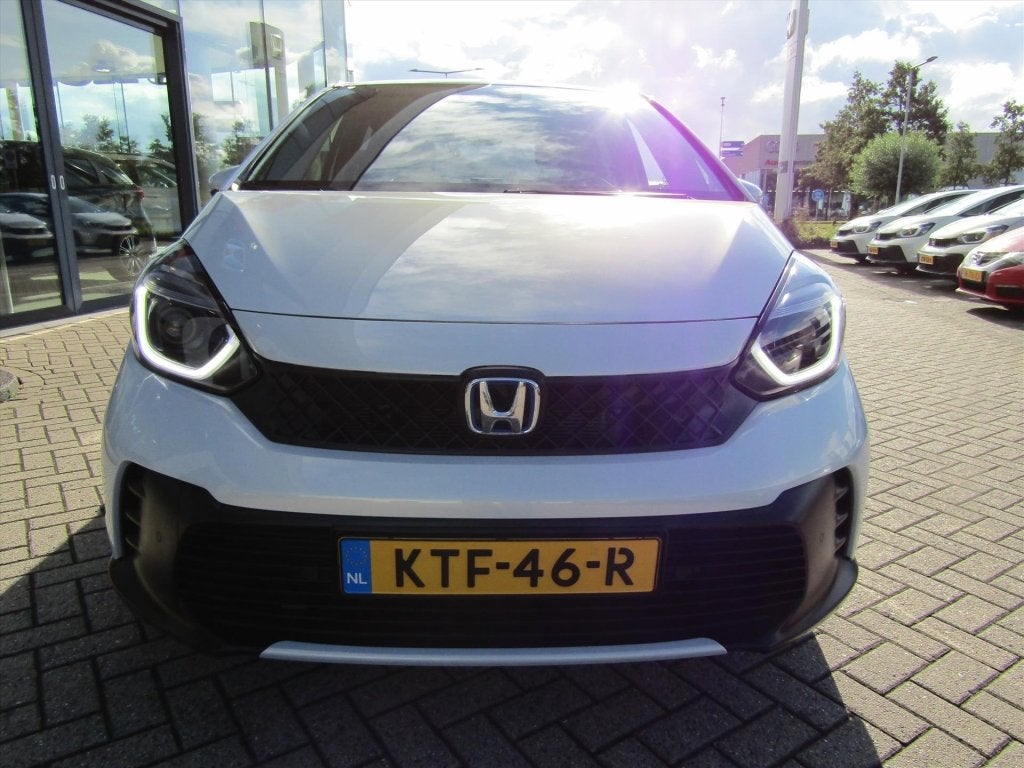 Honda Jazz 1.5 i-MMD 122pk Hybrid CVT (bj 2024), Auto's, Metallic lak, 4 cilinders, Leder en Stof, Wit