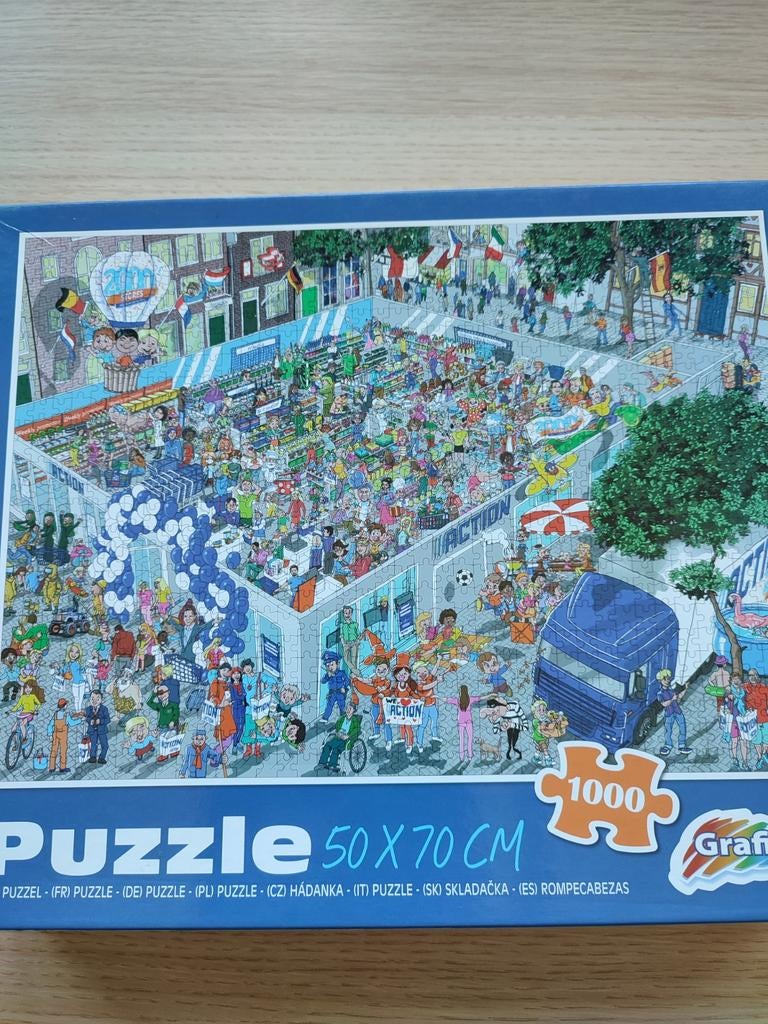 Puzzel 1000 stukjes - Drukte bij de Action, Ophalen of Verzenden, 500 t/m 1500 stukjes, Gebruikt, Legpuzzel