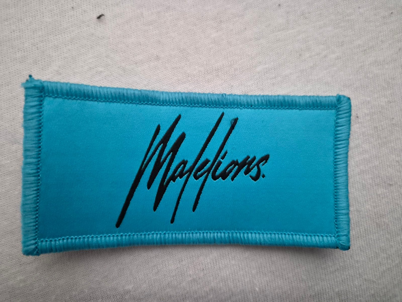 Te koop Malelions klittenband logo blauw, Kleding | Dames, Ophalen of Verzenden