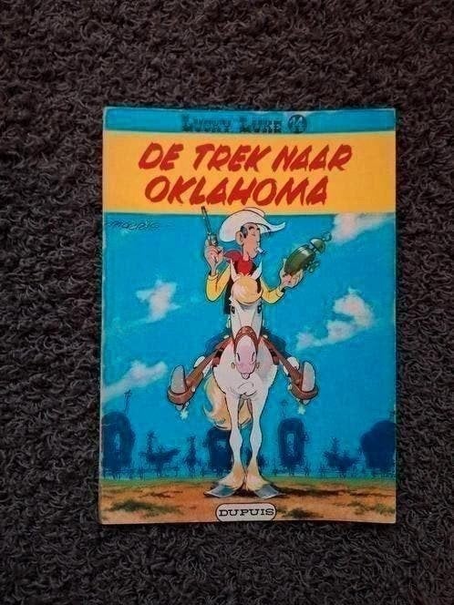 Lucky Luke - De Trek naar Oklahoma (deel 14), Eén stripboek, Ophalen of Verzenden, Gelezen, Morris