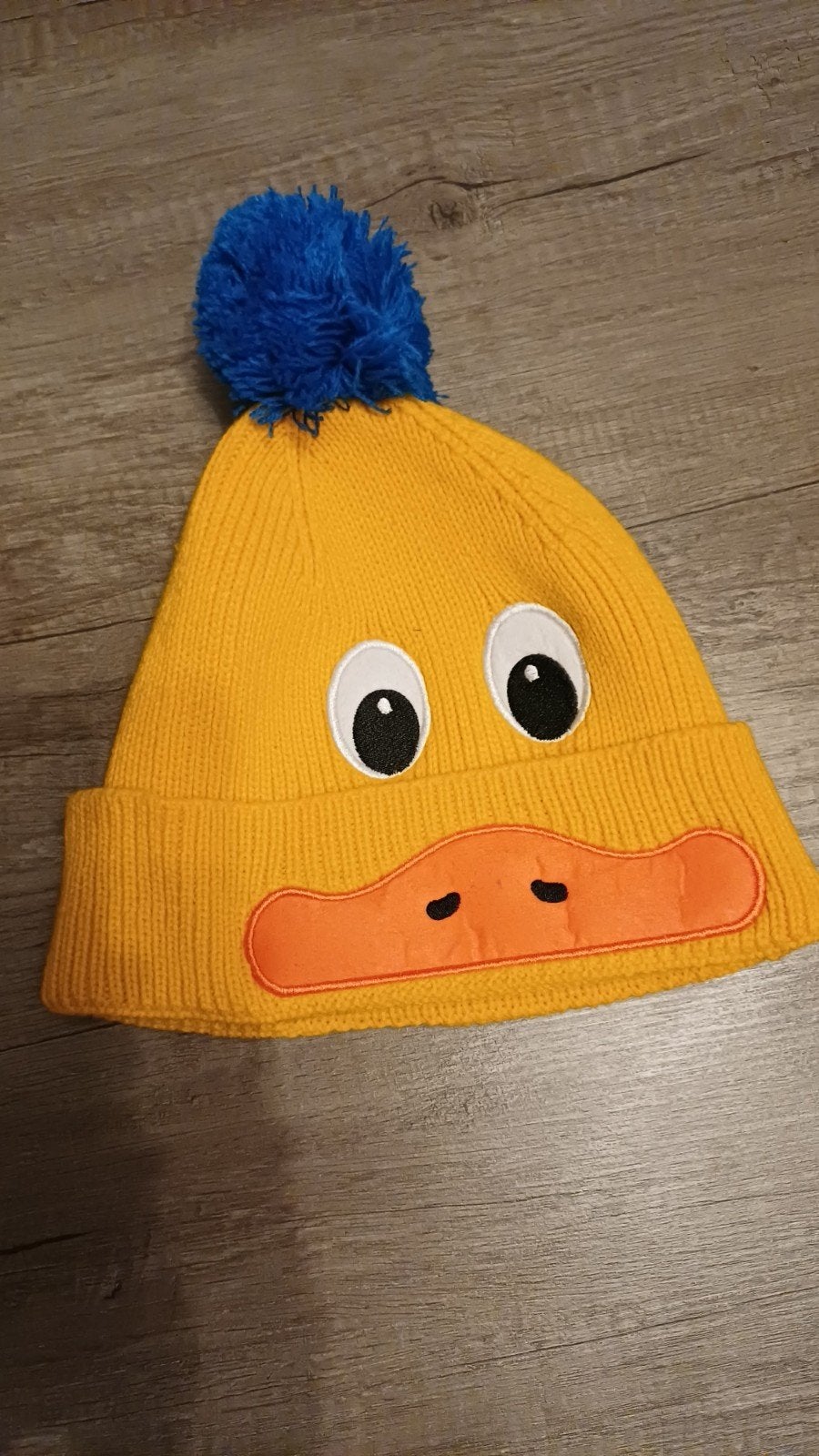 Leuke gele muts met eendengezicht en blauwe pompon, Jongen of Meisje, Ophalen of Verzenden, Zo goed als nieuw, 104 of kleiner