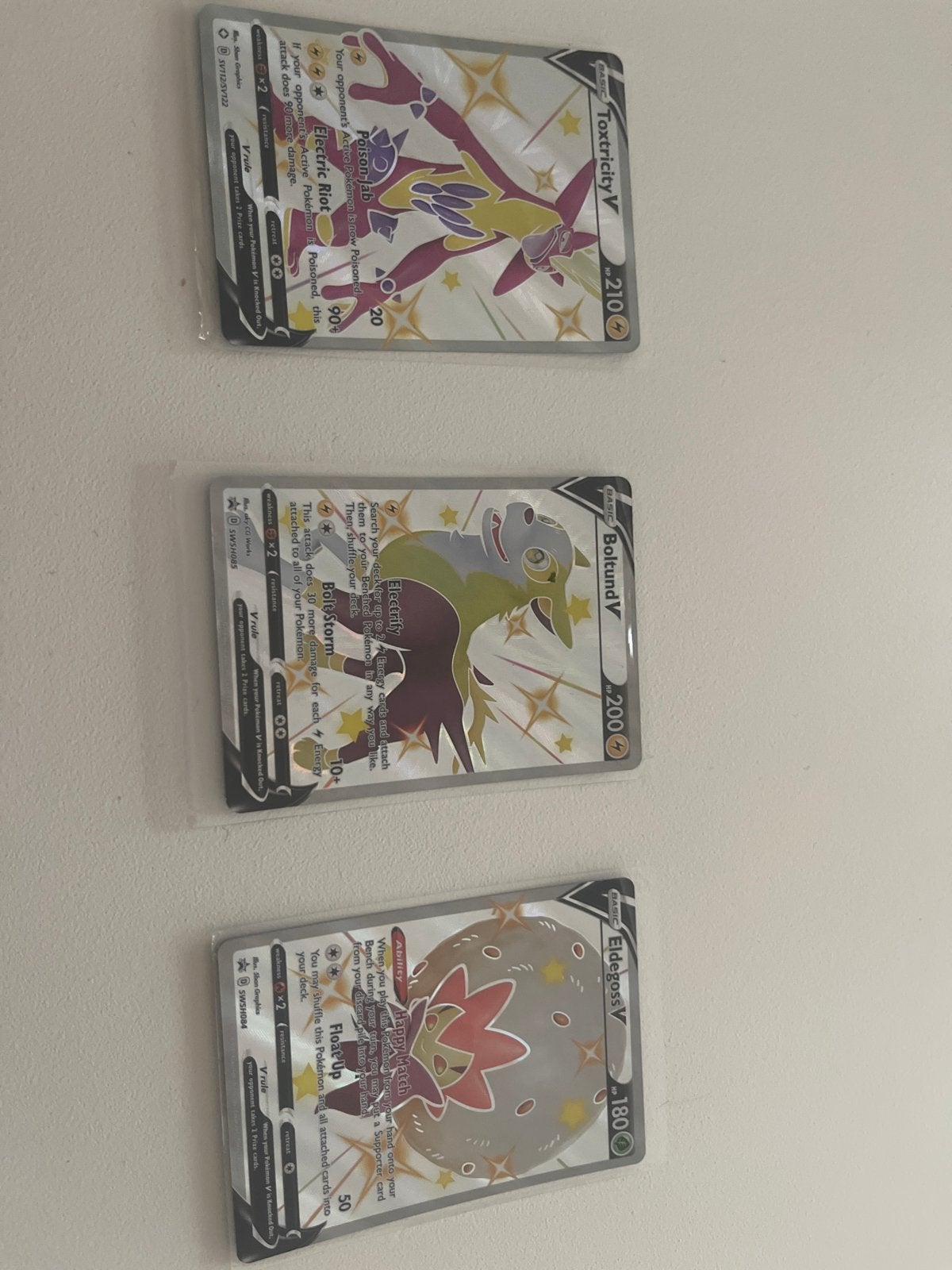 3 Glimmende V-kaarten: Toxtricity V, Boltund V, Eldegoss V, Ophalen of Verzenden, Zo goed als nieuw, Meerdere kaarten, Foil