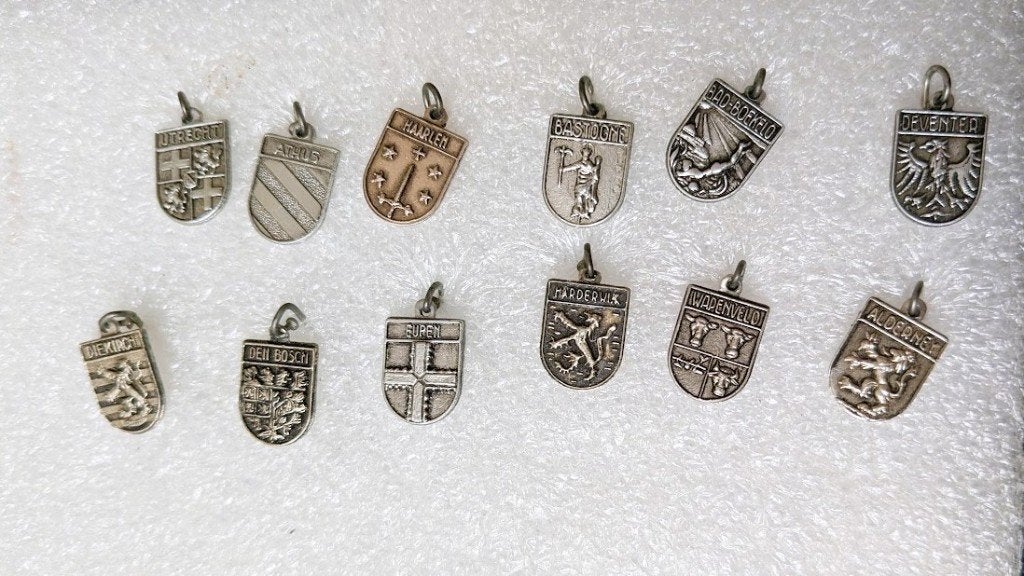 12 metalen hangertjes met wapens van dorp stad e.d., Ophalen of Verzenden, Overige onderwerpen, Speldje of Pin