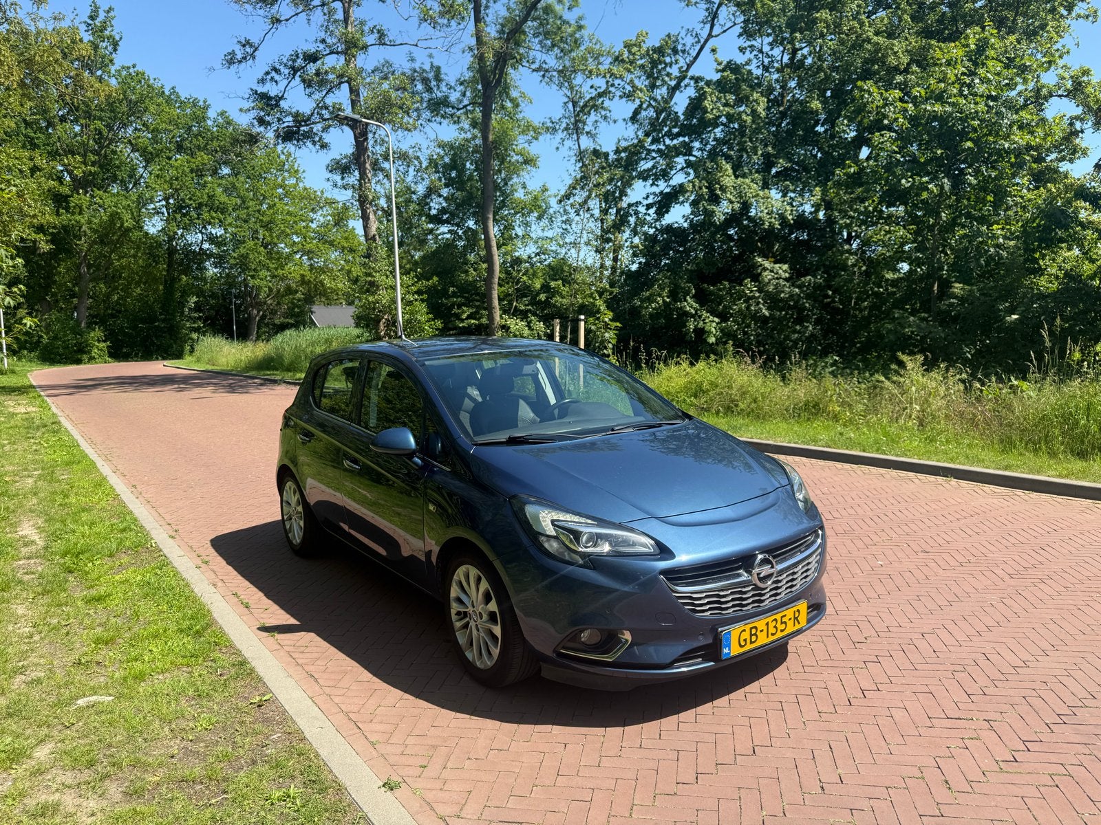Opel Corsa 1.0T 66KW/90PK 5D 2015 Blauw, Auto's, Voorwielaandrijving, Zwart, Blauw, Leder en Stof
