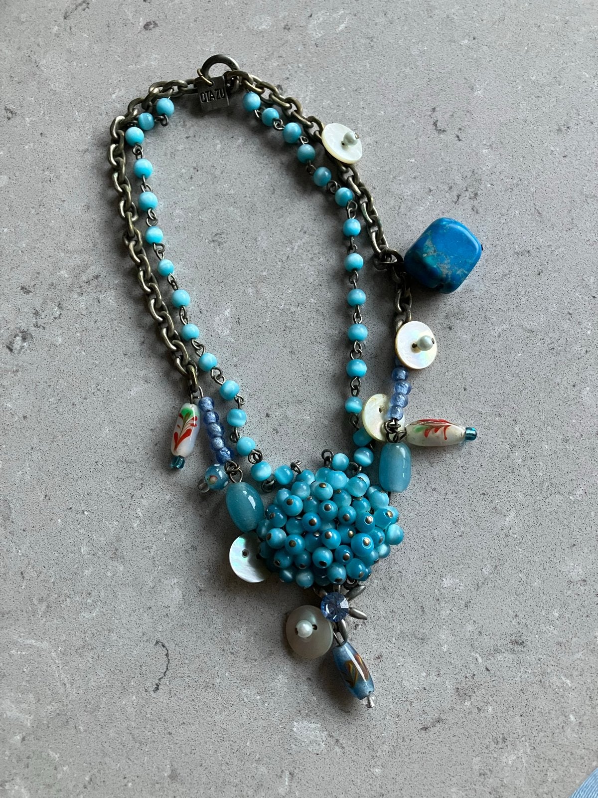 Otazu ketting met blauwe kralen en schelpdetails, Gebruikt, Overige materialen, Met hanger, Verzenden