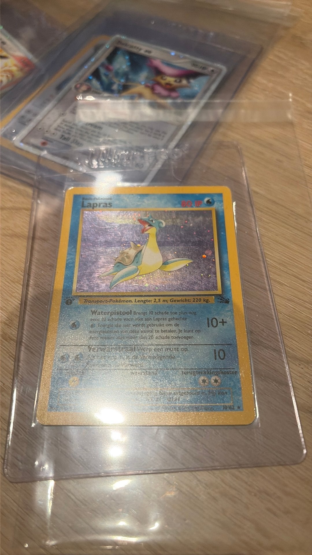 Lapras 10/62 first edition holo, Hobby en Vrije tijd, Verzamelkaartspellen | Pokémon, Ophalen of Verzenden, Zo goed als nieuw
